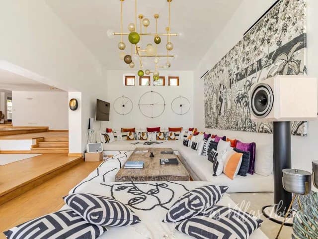 Bedroom with patterned wall covering, bold textiles and a cast iron wood stove, Sant Jordi de Ses Salines, Ibiza