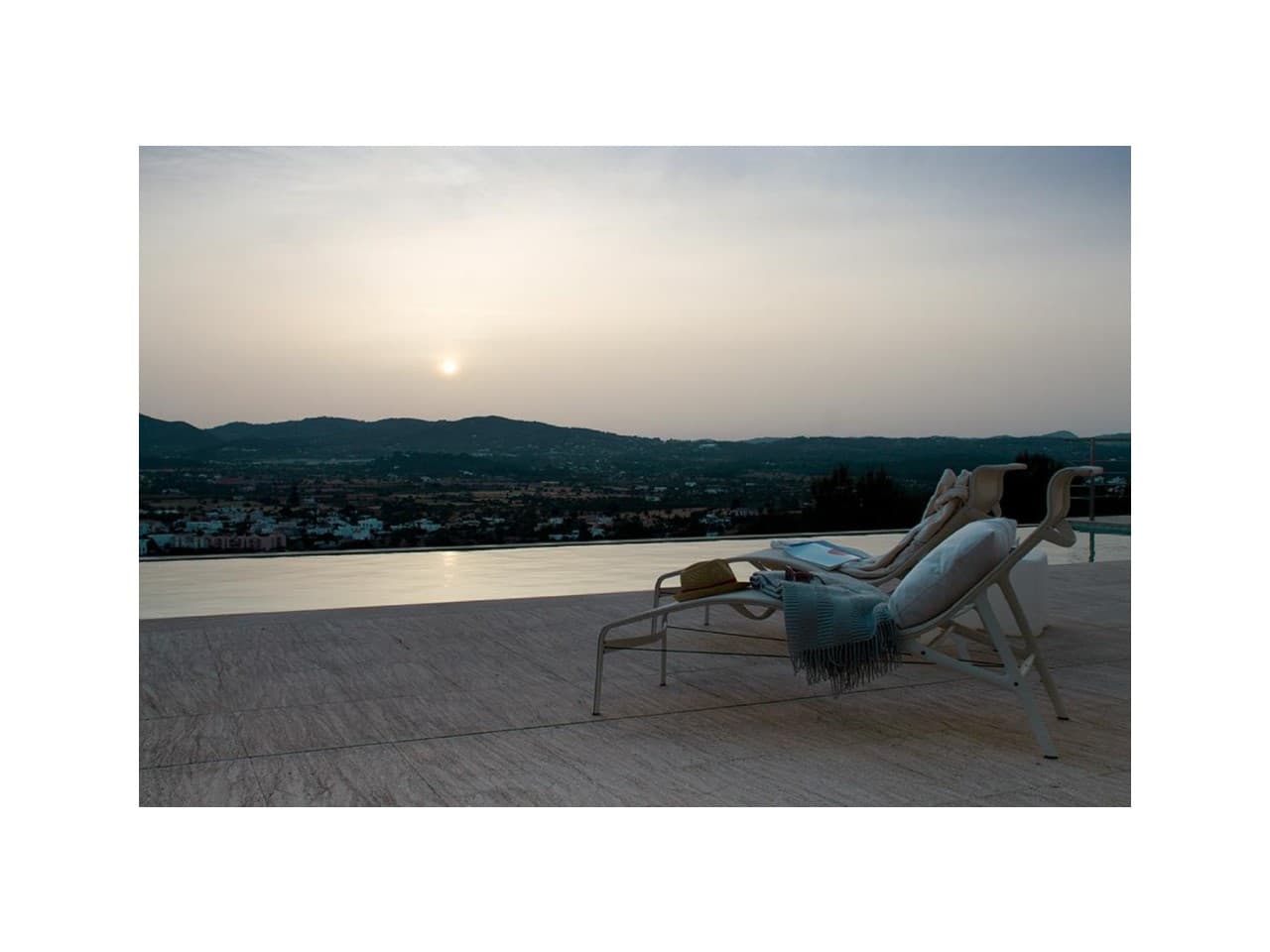 Sun lounger facing the sunset over the hills at Villa K4, Can Rimbau, Ibiza