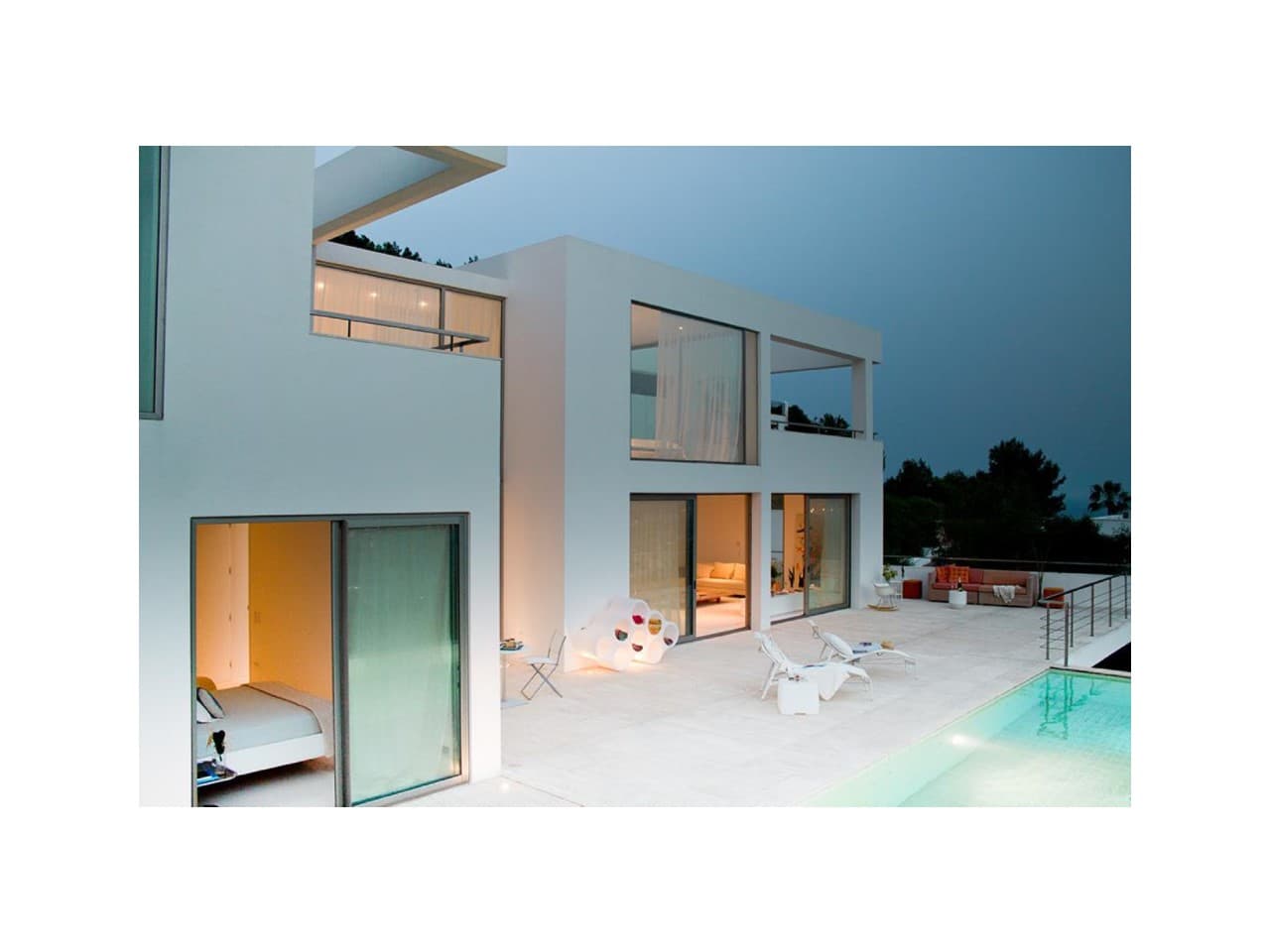 Contemporary villa with a swimming pool and glazed living spaces at Villa K4, Can Rimbau, Ibiza