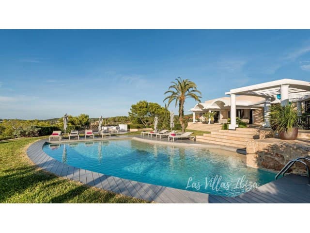 Swimming pool with sun loungers and mature palms at Can Rasa, Sant Josep, Ibiza