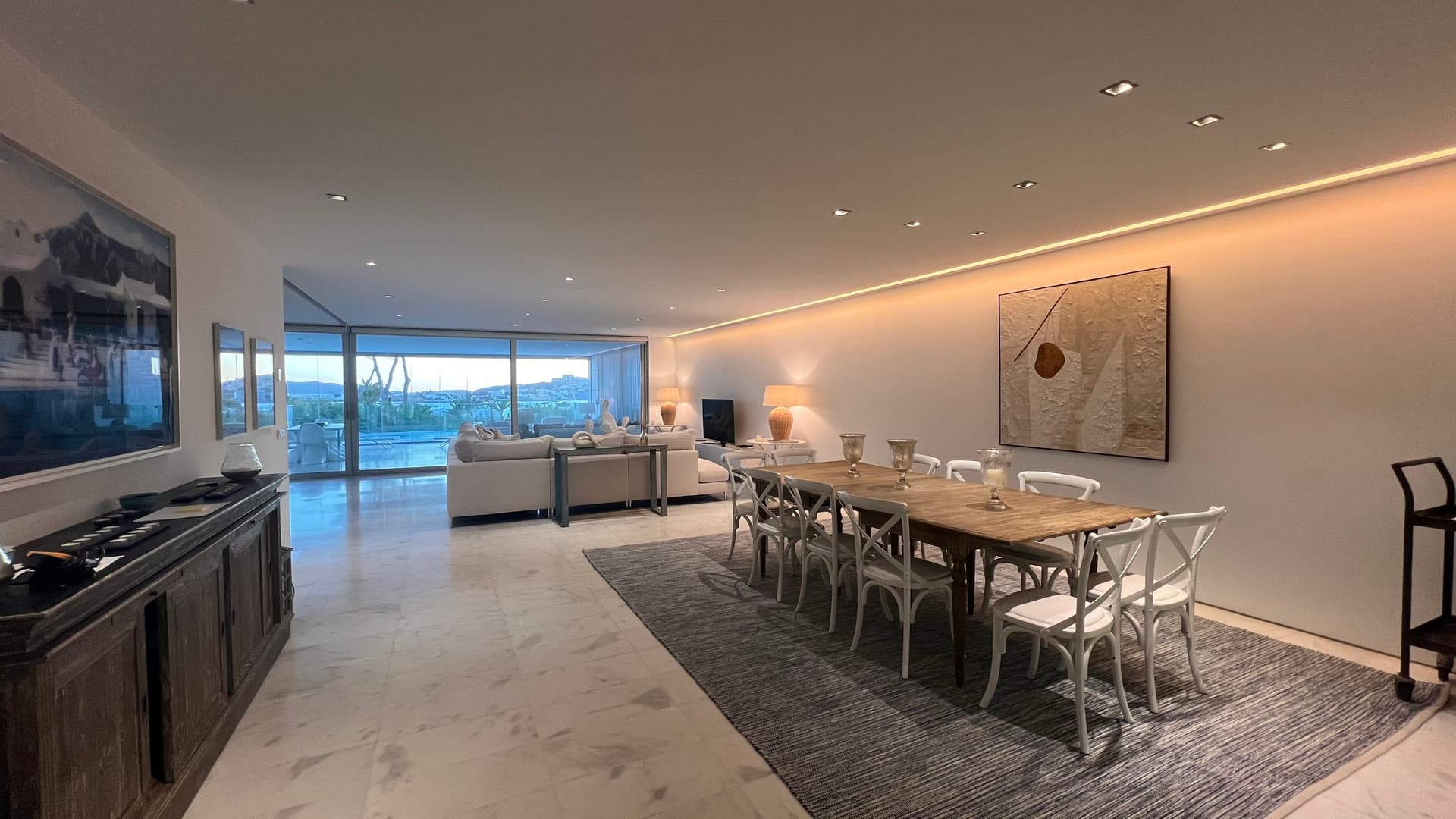 Long dining table with the sea beyond in a luxury apartment, private urbanisation, Ibiza