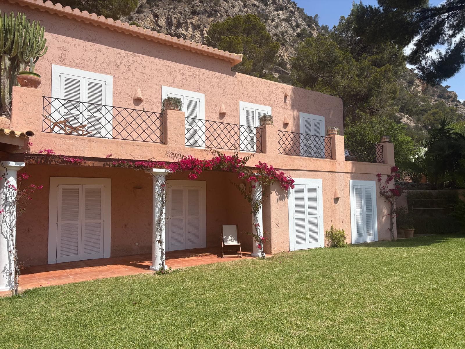 Bougainvillea climbing the balconied facade at Casa Hermosa, Es Cubells, Ibiza