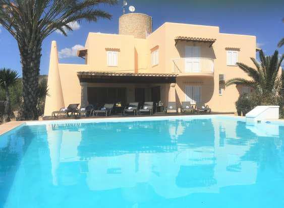 Rendered villa with a large swimming pool and mature palms, Sant Jordi de Ses Salines, Ibiza