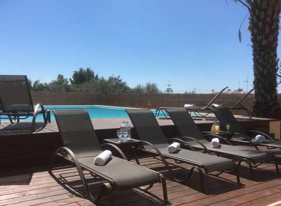 Sun loungers lined along the pool with open countryside beyond, Sant Jordi de Ses Salines, Ibiza