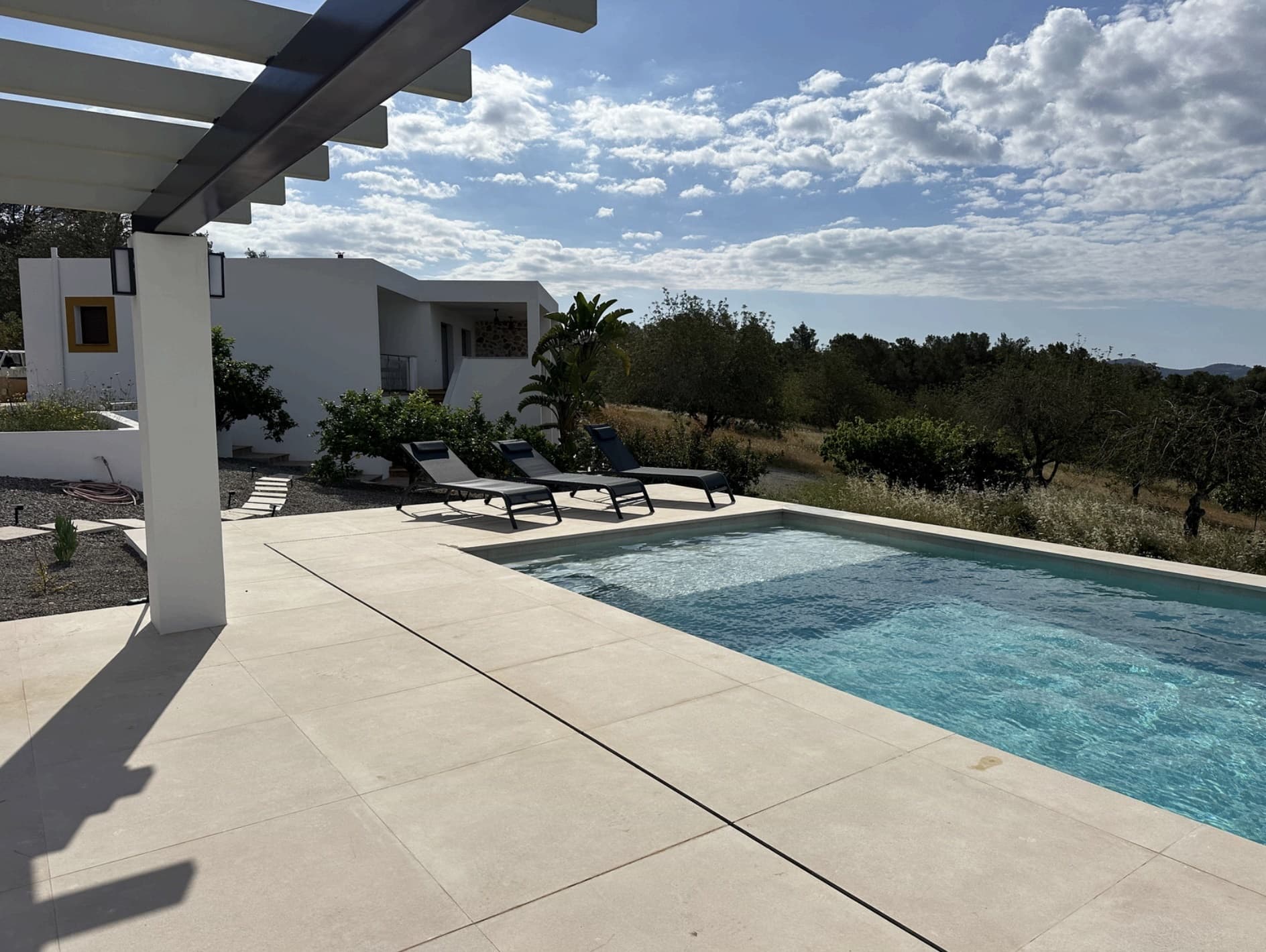 Swimming pool and terrace looking over open countryside at Can Cata, Santa Gertrudis, Ibiza
