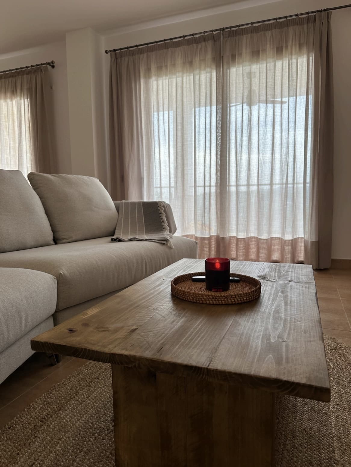 Living room with a deep sofa and rustic timber table at Can Cata, Santa Gertrudis, Ibiza