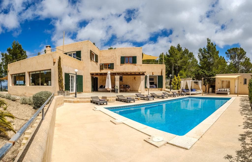 Swimming pool and sun loungers below the sandstone facade at Can Mistique, Sant Josep de Sa Talaia, Ibiza
