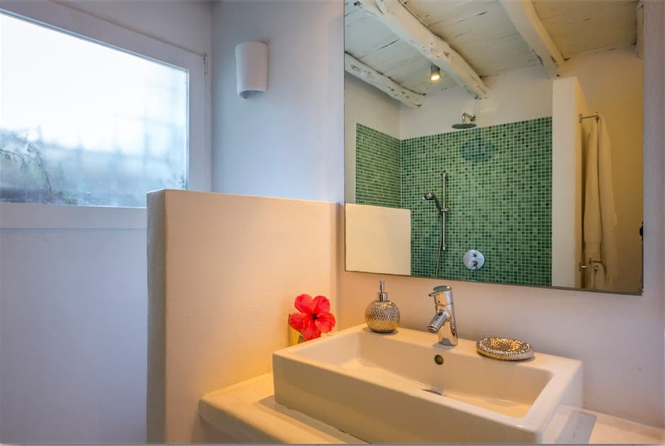 Bathroom with a green tiled shower and timber vanity at Villa Predo, Es Cubells, Ibiza