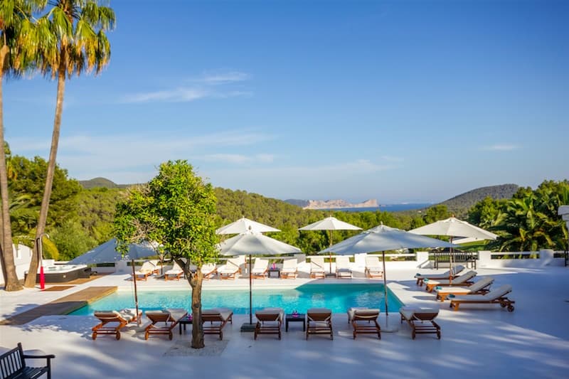 Sun loungers and parasols along the swimming pool at Villa Predo, Es Cubells, Ibiza