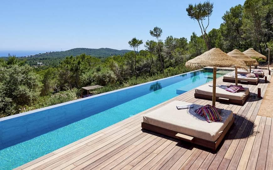 Daybeds beside the infinity edge looking across the hills at Villa Regaliz, Sant Josep, Ibiza