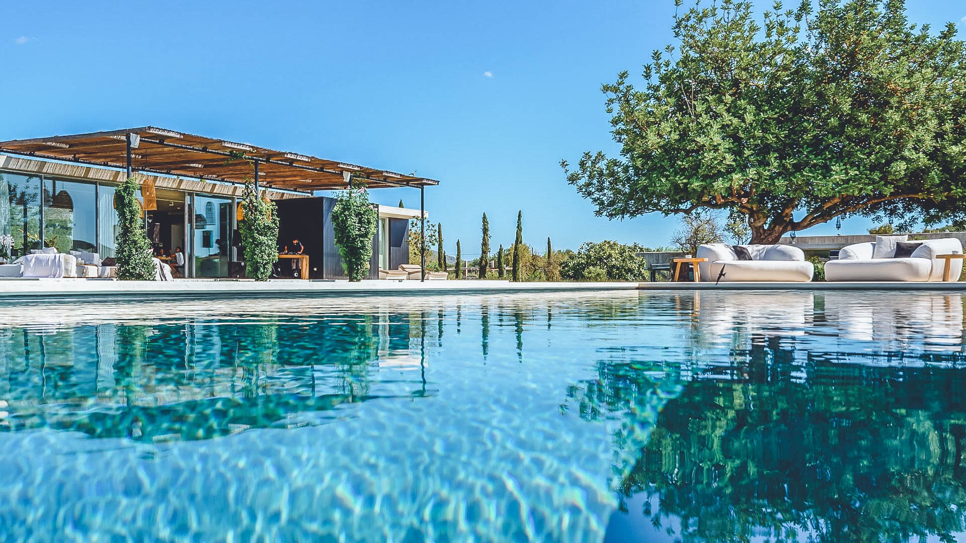 Swimming pool set between mature trees at Villa Bianca, Sant Joan de Labritja, Ibiza