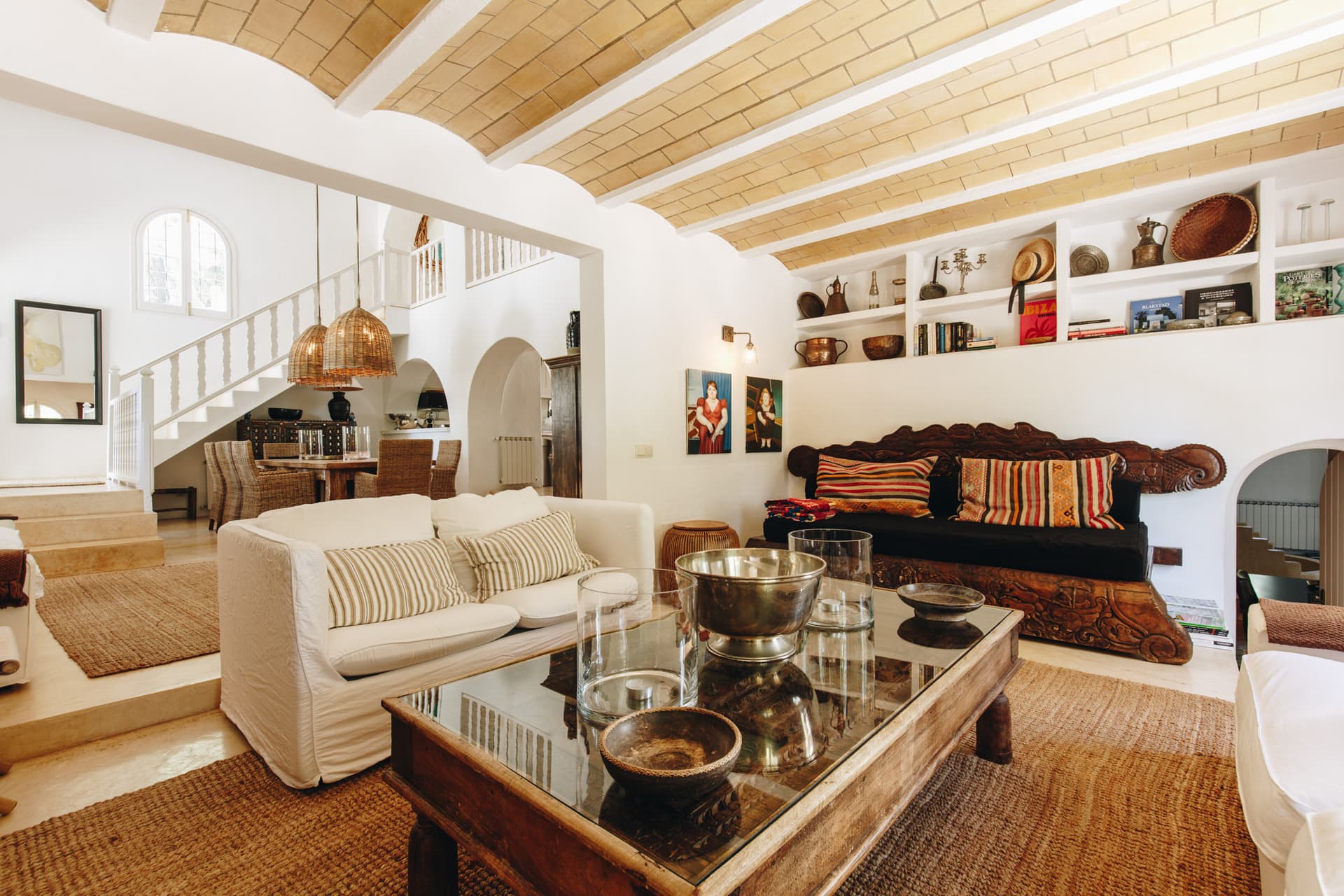 Living room with a beamed ceiling and built in shelving at Villa Charo, San Rafael, Ibiza