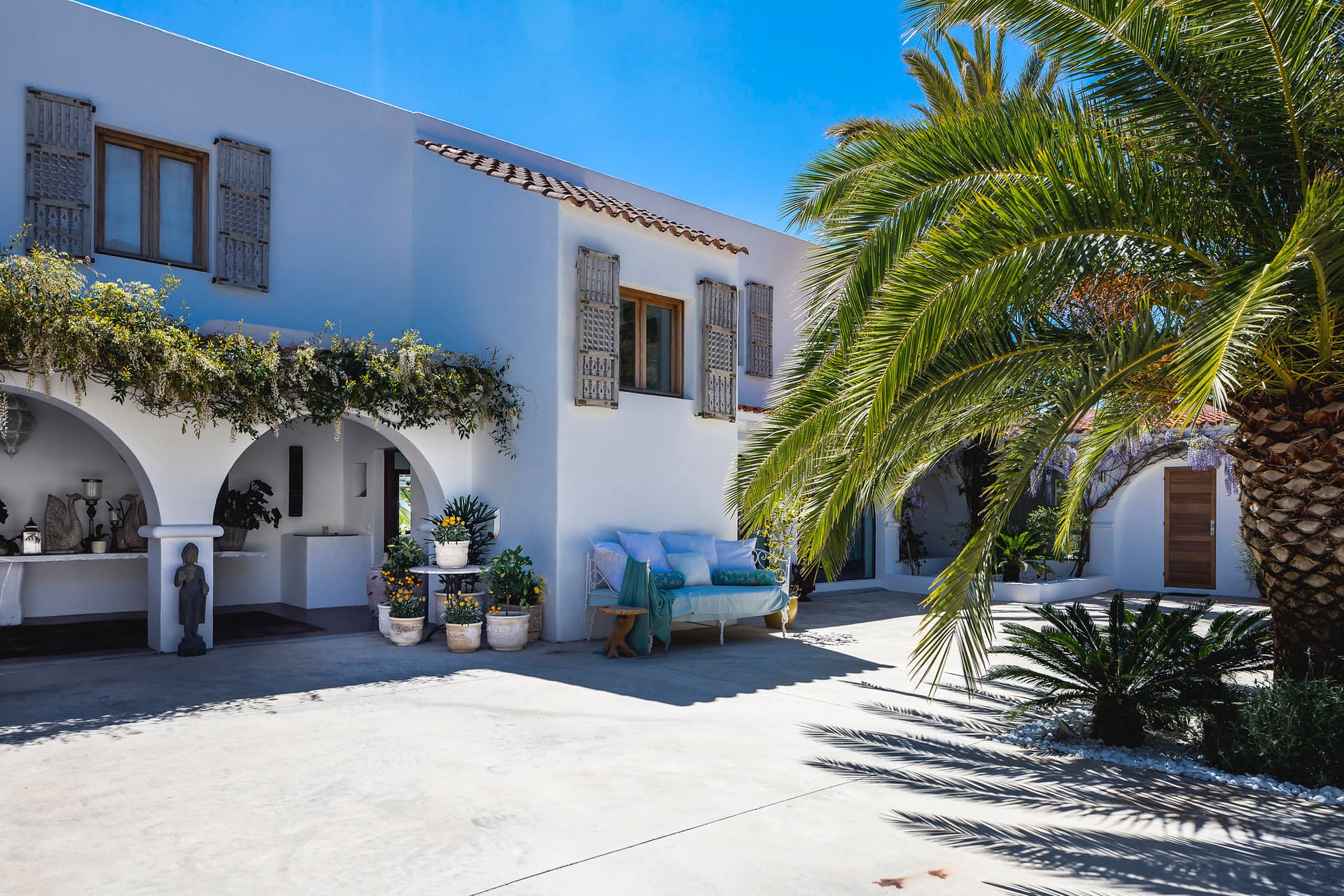 Whitewashed arcades and mature palms at Villa Meghan, Sant Josep, Ibiza