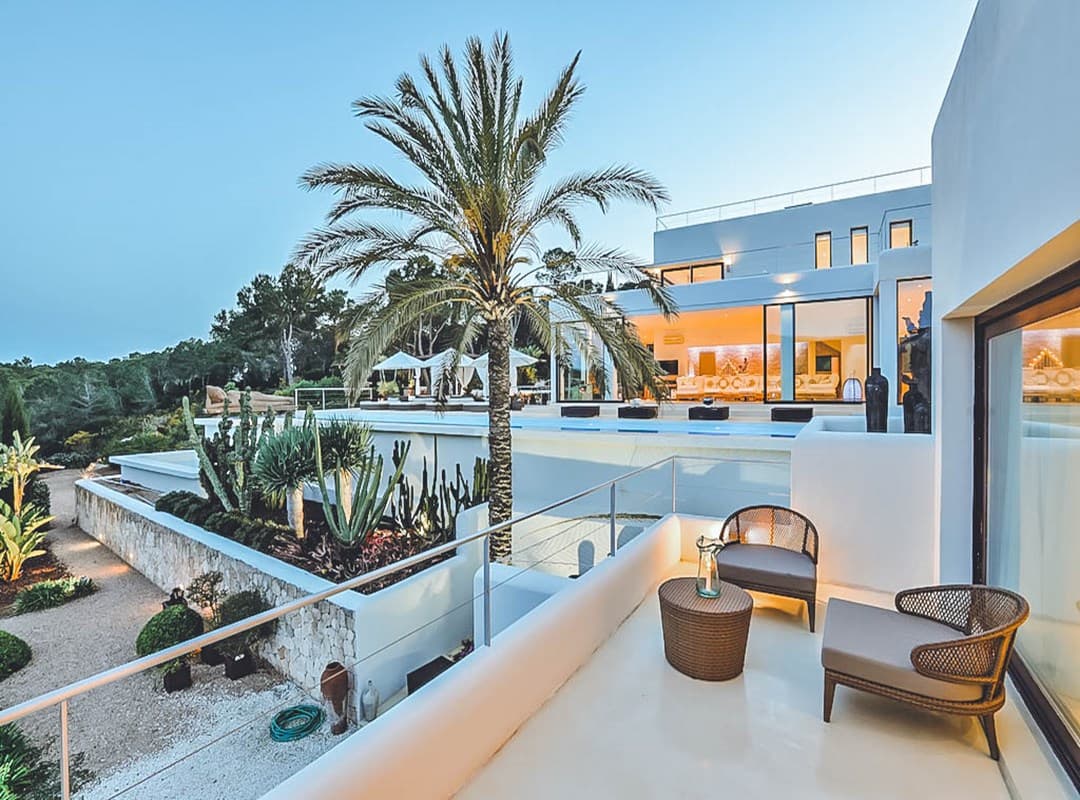 Terrace with mature palms beside the swimming pool at Villa Paola, Cala Jondal, Ibiza