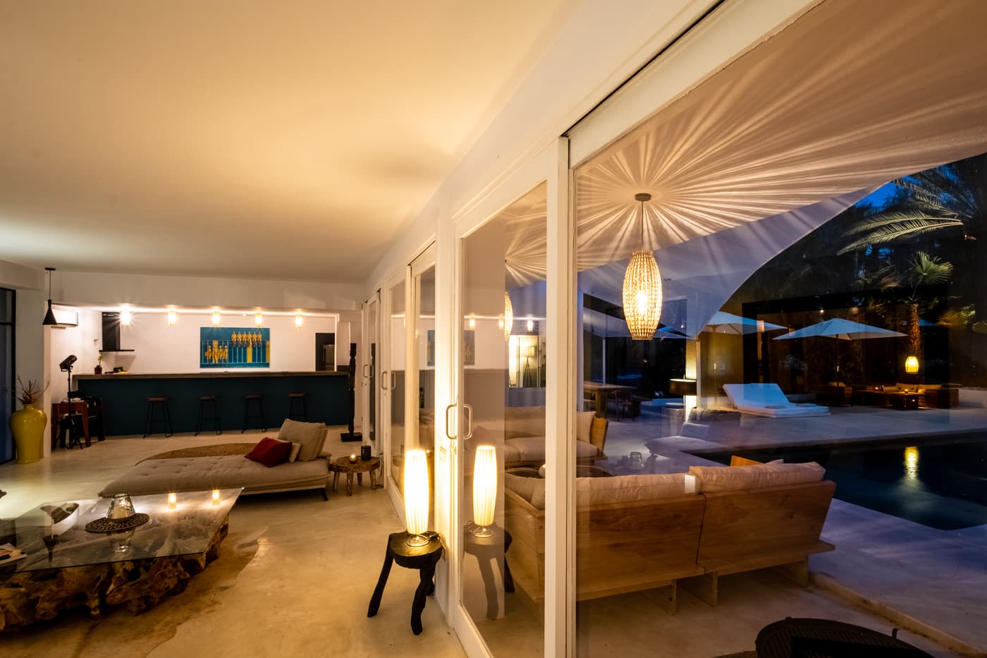 Living room in warm evening light opening to the terrace at Villa Zola, Roca Llisa, Ibiza