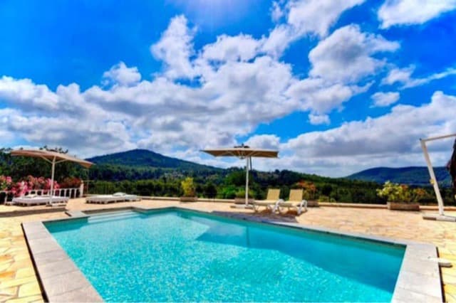 Swimming pool looking out across open countryside at Can Eucalipto, Sant Josep, Ibiza
