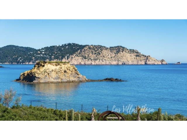 Rocky islet and clear water in the bay below Villa Bellalux, Sant Carles, Ibiza