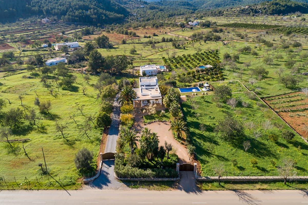 Aerial view of Villa Amanecer set among green fields and farmland, Sant Antoni de Portmany, Ibiza