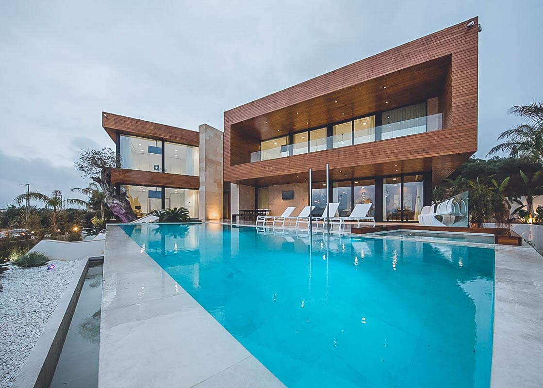 Timber clad contemporary villa running the length of the swimming pool at Villa Val, Talamanca, Ibiza