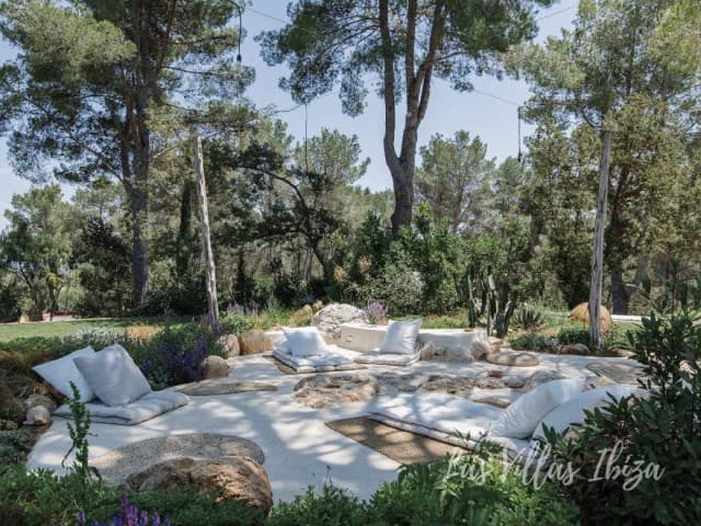 Sun loungers set among natural rock in the garden at Can Mulo, Sant Antoni de Portmany, Ibiza