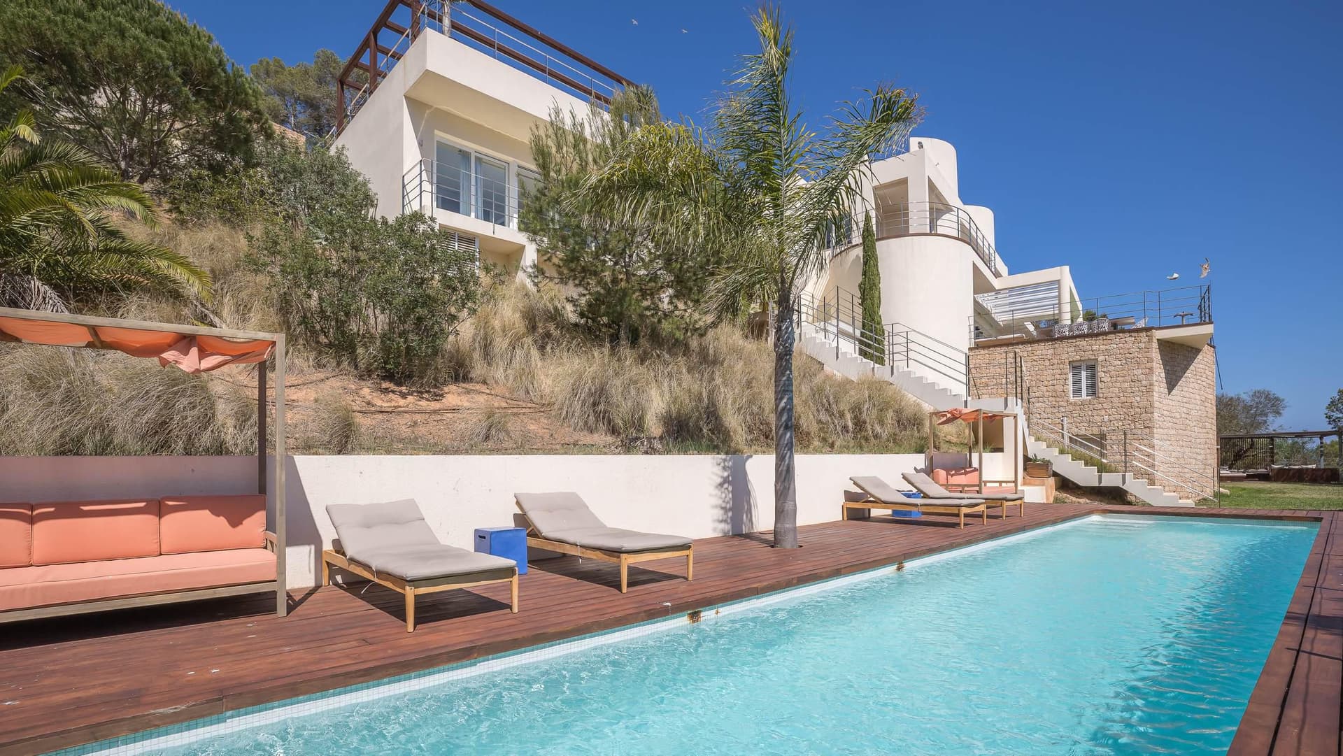 Stepped terraces leading down to the swimming pool at Villa Blue Rock, Roca Llisa, Ibiza
