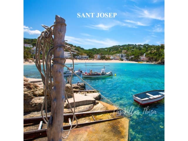 Moored boats and clear water in a cove on the Sant Josep coast, near Can Nik, Ibiza
