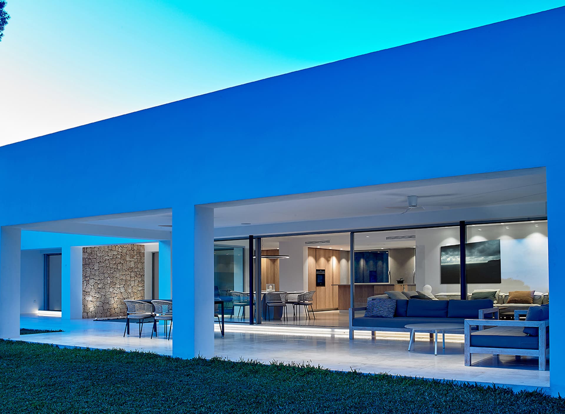 Contemporary villa with full height glass opening onto the lawn at Can Nuri, Sant Jordi de Ses Salines