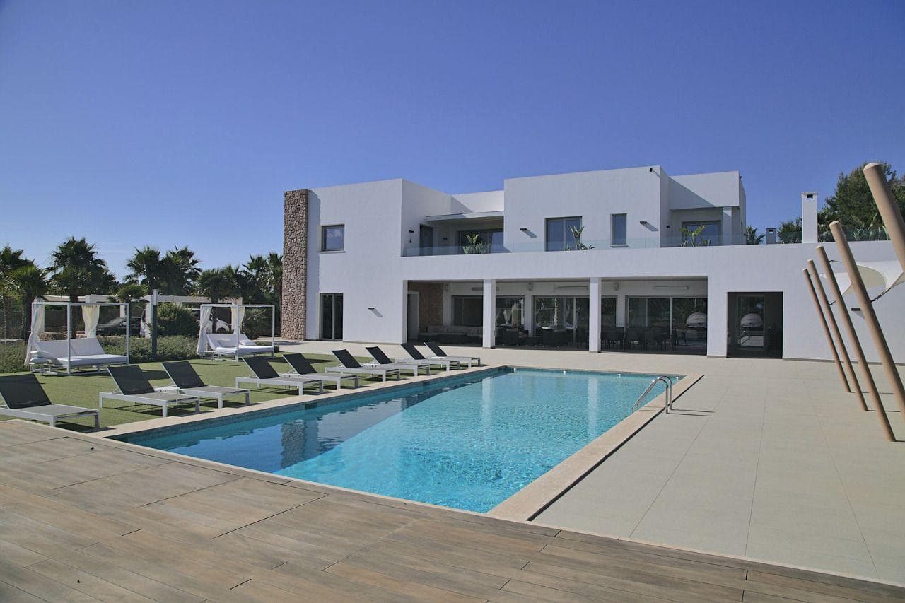 Contemporary white villa with a long swimming pool and sun loungers at Casa Fourteen, Jesus, Ibiza