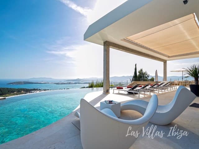 Terrace with sculptural seating beneath a canopy looking over the bay at Villa Abigail, Talamanca, Ibiza