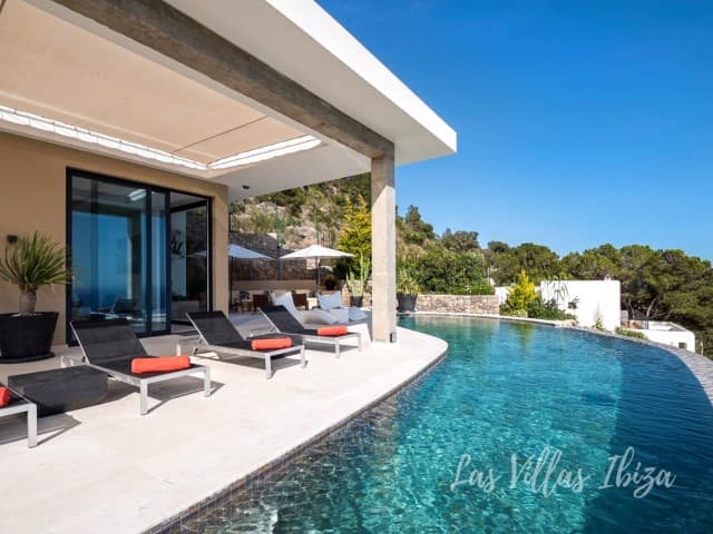 Swimming pool with loungers beside the covered terrace at Villa Abigail, Talamanca, Ibiza