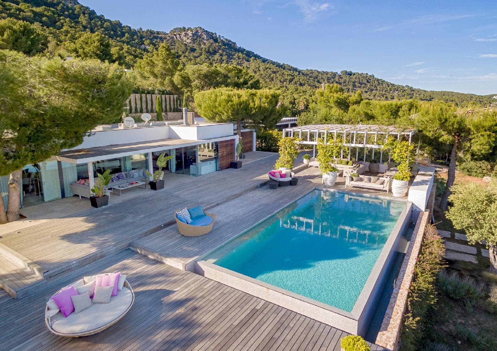 Swimming pool and white terraces below the mountain at Villa Belle, Es Cubells, Ibiza
