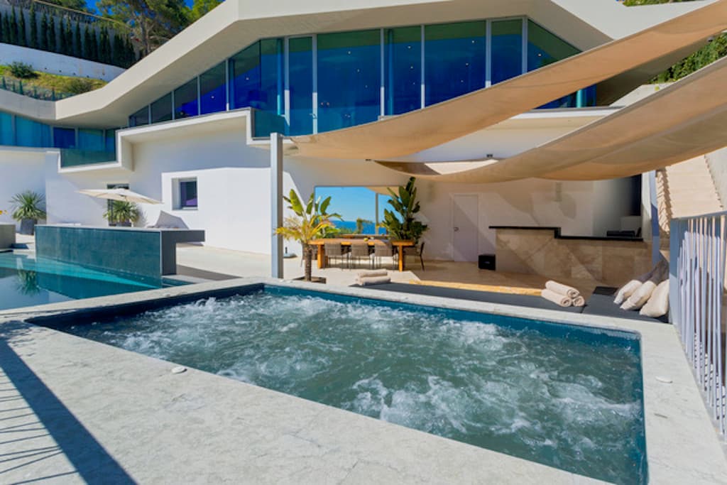 Contemporary villa with a curved roof above the swimming pool at Villa Estelle, Roca Llisa, Ibiza