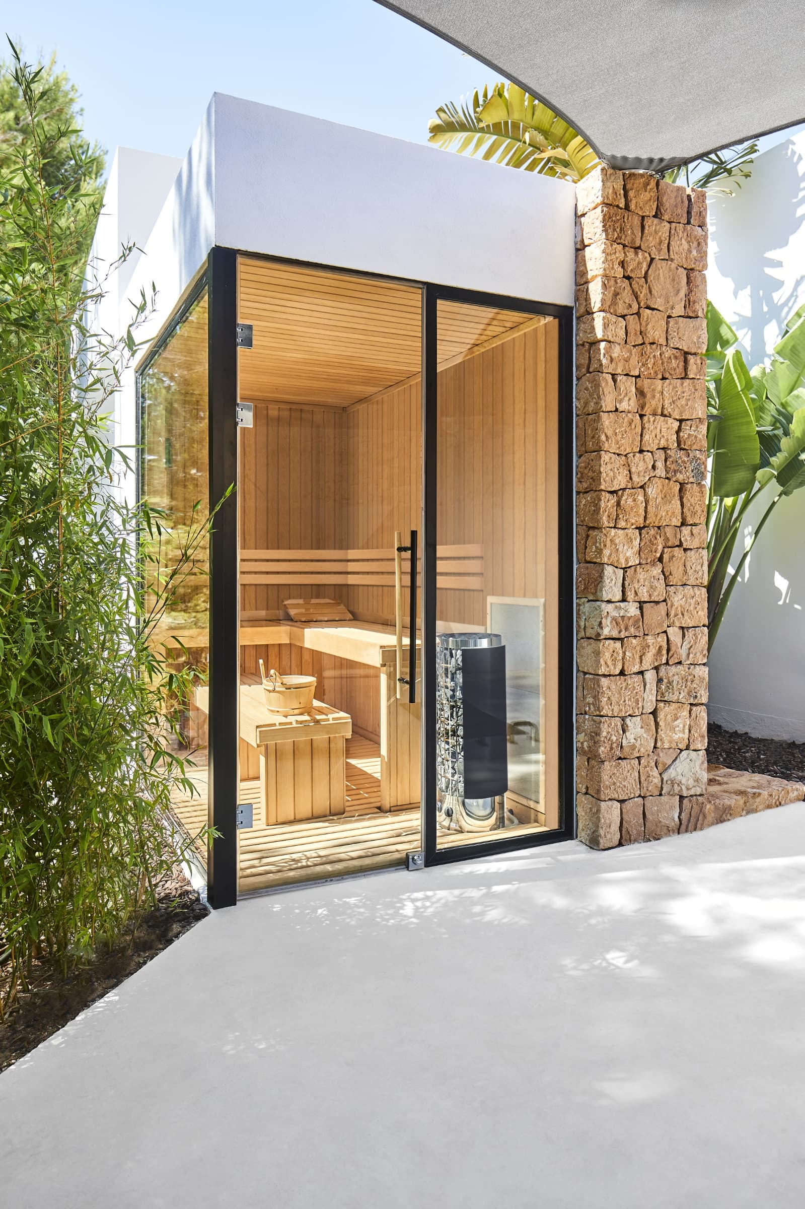 Contemporary villa with a stone clad wall and full height glazing at Villa Lucy, Sant Josep, Ibiza