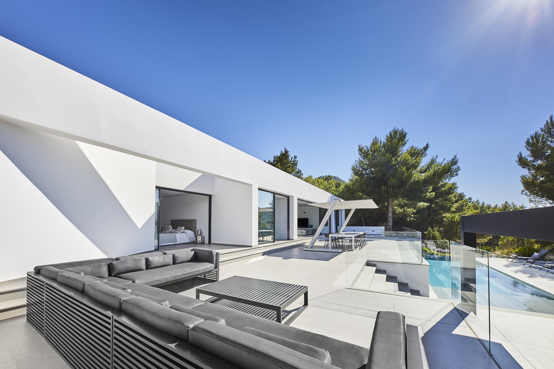 White contemporary villa with a swimming pool and sun loungers at Villa Lucy, Sant Josep, Ibiza