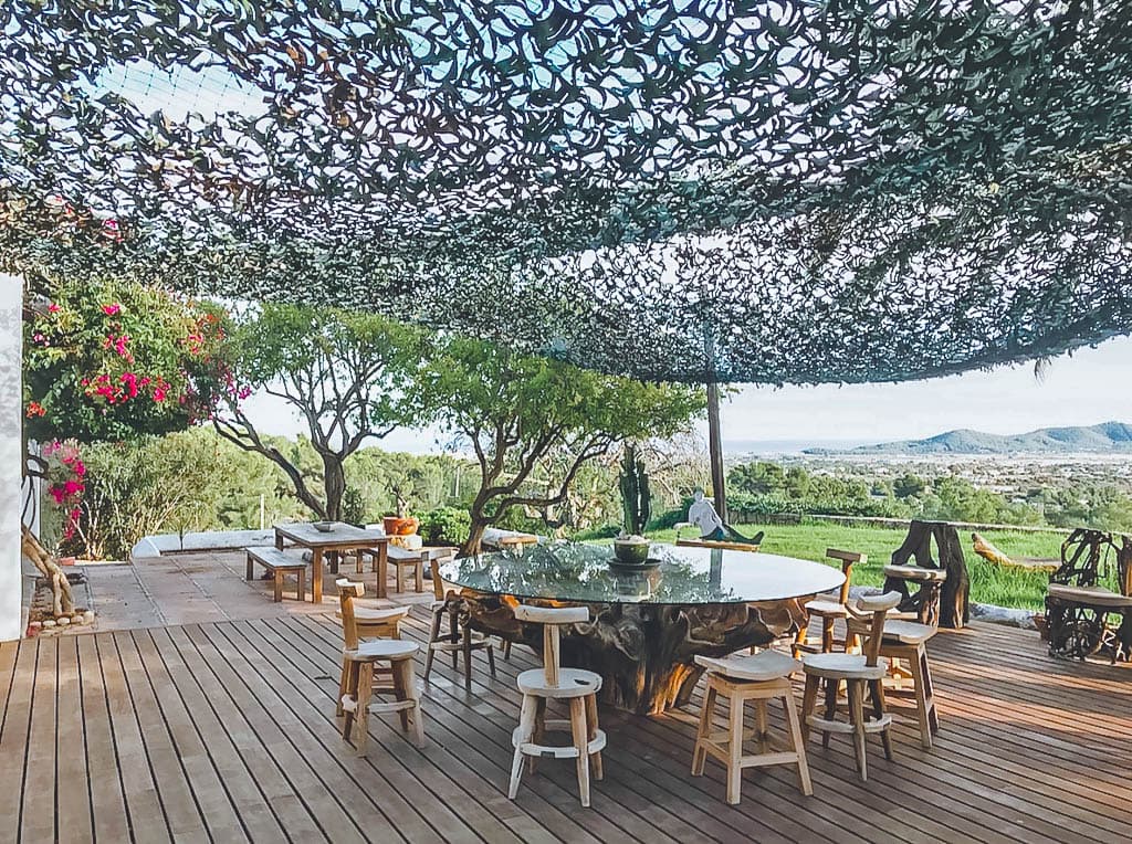 Outdoor dining on a timber deck beneath a patterned canopy at Villa Margo, Sant Josep, Ibiza