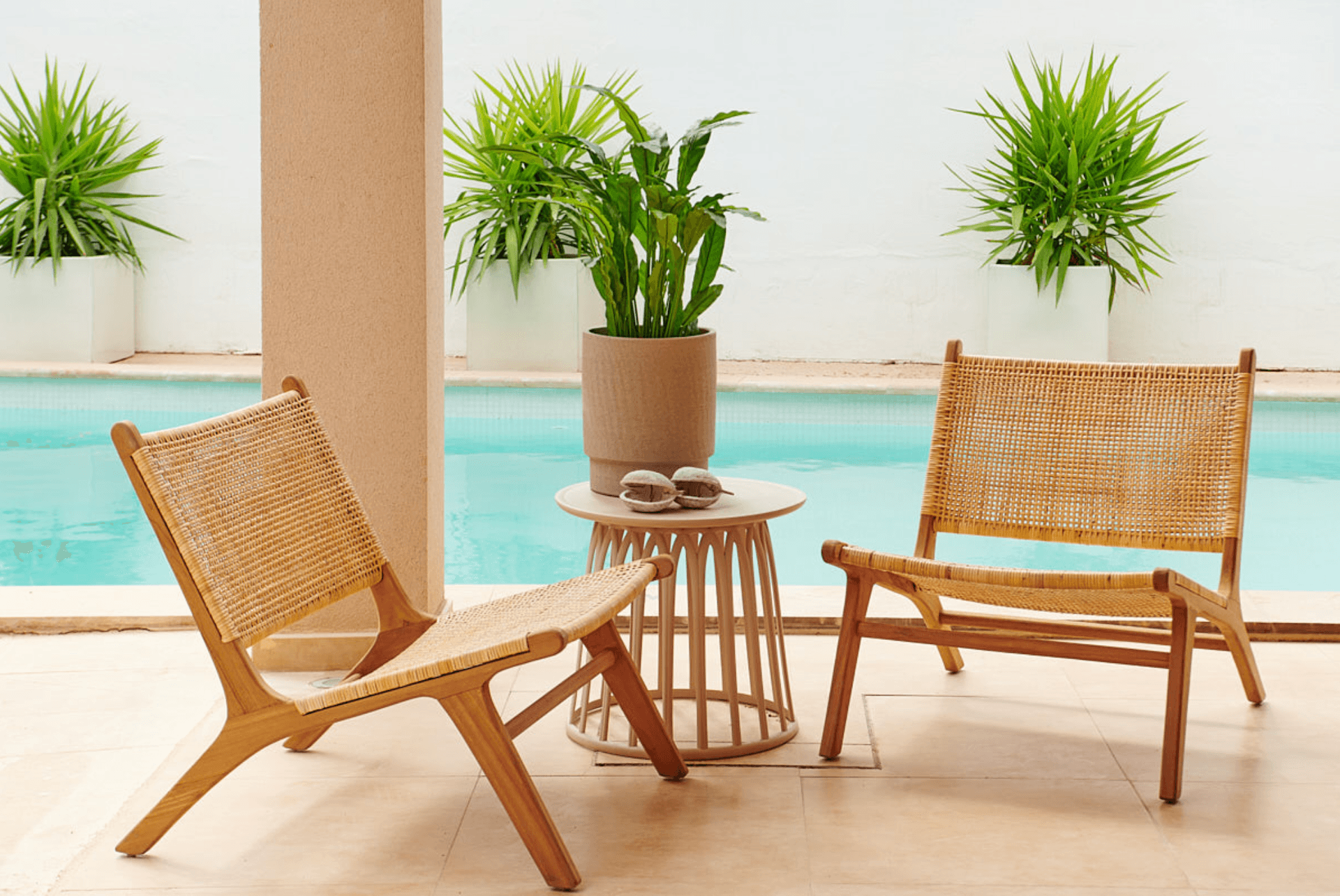 Terrace chairs among potted planting beside the pool, Jesus, Ibiza