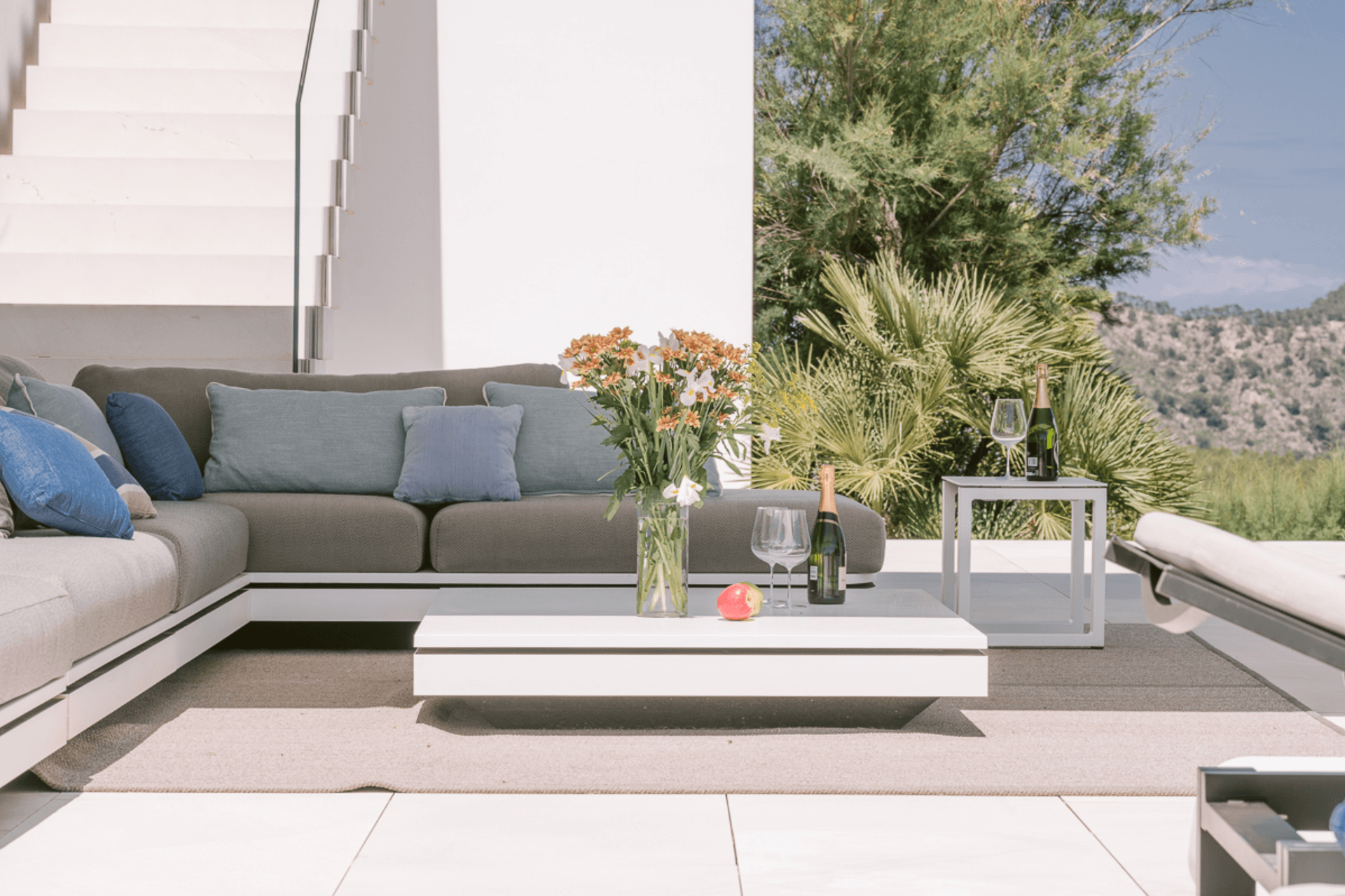 Terrace with grey outdoor seating beside a mature palm, newly built villa, Ibiza
