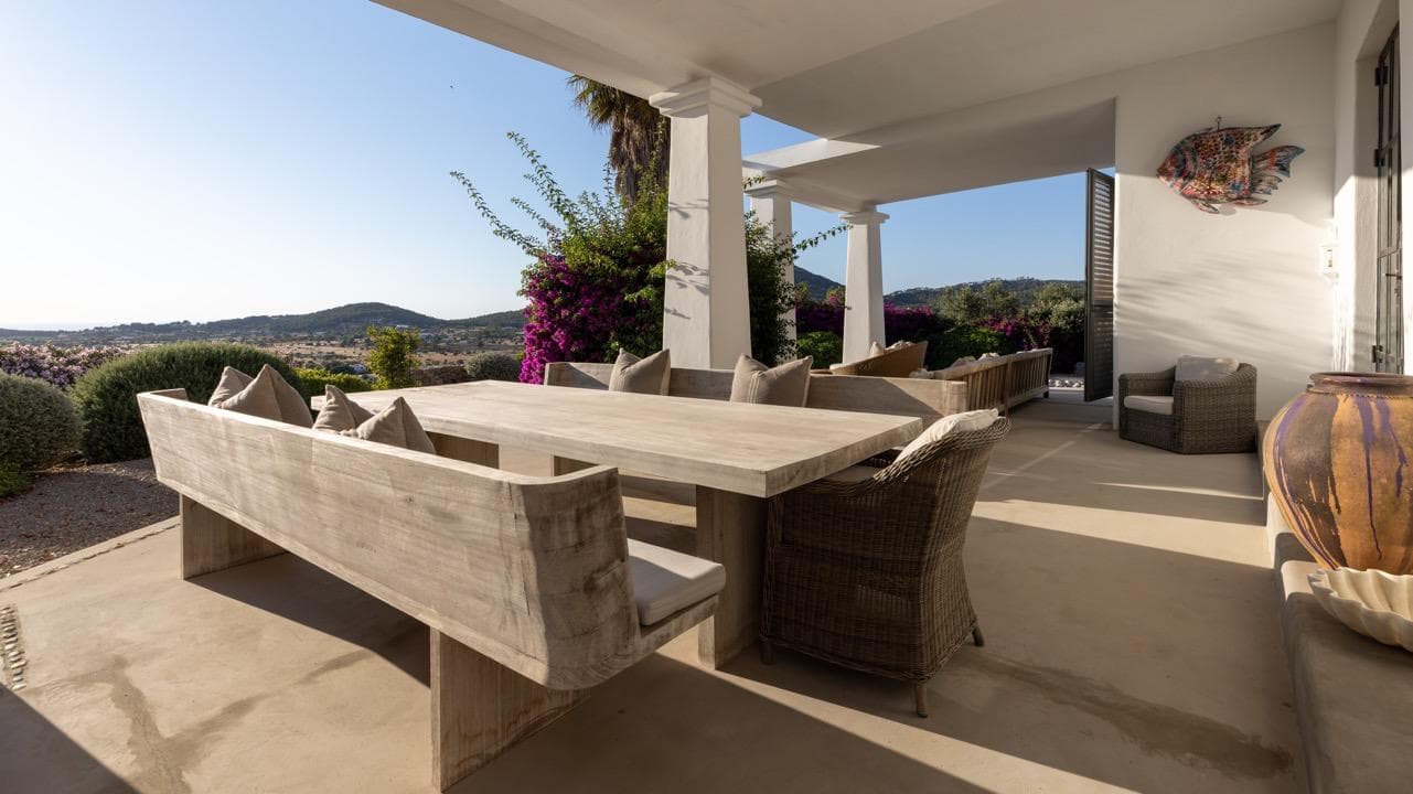 Outdoor dining on a colonnaded terrace looking out to the sea, Ibiza