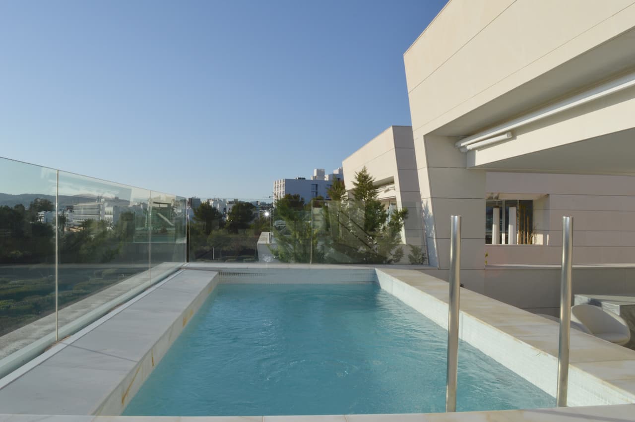 Swimming pool with a glass balustrade at a luxury apartment in Es Pouet, Talamanca, Ibiza